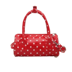 Chic red polka dot cylinder shoulder bag in glossy patent leather with top handles