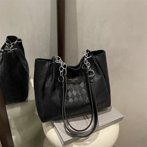 Minimalist black quilted tote bag with silver chain strap for women's daily commute
