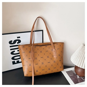 Detail of the brown tote bag featuring textured PU leather and LNBOE monogram patterns