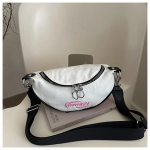 Detail of white half-moon crossbody bag with pink embroidery and black strap