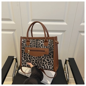 Detail of trendy leopard print handbag with zip pocket and dual carrying handles