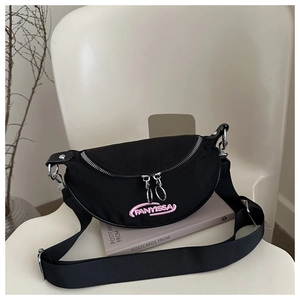Detail of pink embroidered logo on black nylon half-moon crossbody bag with silver zippers