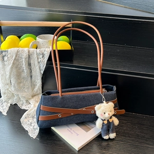 Denim baguette shoulder bag with brown leather straps and cute plush bear charm