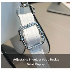 Close-up of adjustable white leather strap with silver metal buckle and neat stitching