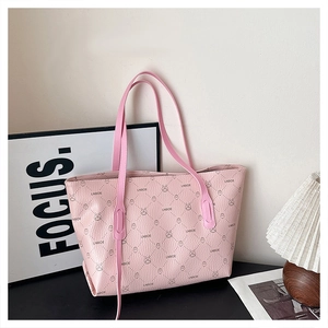 Detail of pink tote bag with rabbit monogram print and premium faux leather texture