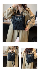 Detail of black backpack with butterfly embroidery, ruffles, and a pearl pendant charm