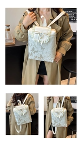 Detail view of cream leather backpack with lace trim, bow and pearl charms for women