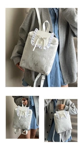 Detail of cream PU leather backpack featuring lace trim, bowknot, and pearl pendant decor