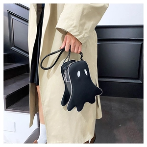 Detailed view of the cute ghost-shaped black crossbody bag with white embroidered eyes
