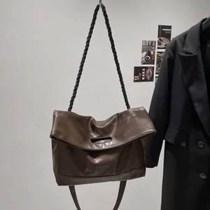 Minimalist brown PU leather tote bag with thick black knotted rope strap and cutout handle