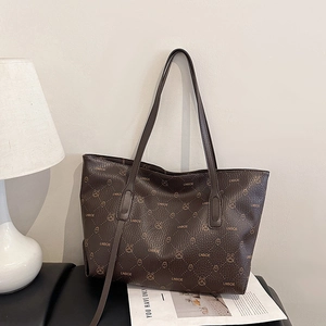 Vintage dark brown tote bag with all-over logo print and slim shoulder straps for women