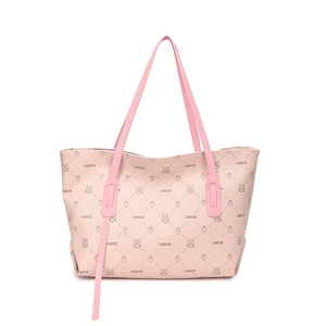 Pink faux leather tote bag with vintage cartoon prints and top handles on white background