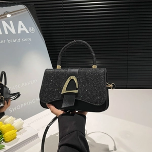 Fashionable black sequin handbag with gold triangle buckle and crossbody strap