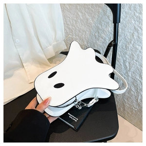 Close-up of ghost-shaped PU leather handbag with black eye appliques and fine edge detailing