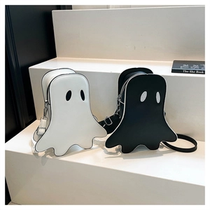 Detail view of black and white ghost-shaped crossbody bags with premium zipper closure