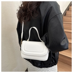 White leather crossbody bag with textured stripes shown from a stylish back view perspective