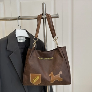 Dark brown minimalist tote bag with Tidal Dryness print and puppy patch detail