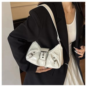 Detail view of white patent leather shoulder bag featuring silver buckle and retro Y2K style