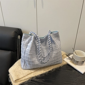 Light blue tote bag with plaid texture and woven handles for casual daily commute use