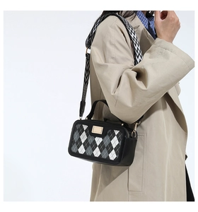 Detail of Korean style plaid handbag with textured wide geometric fabric strap