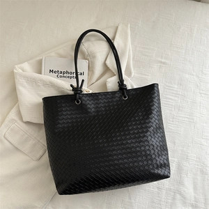 Minimalist black woven leather tote bag with large capacity and sleek top handle strap