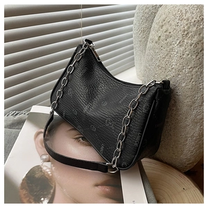 Detailaufnahme einer schwarzen Leder-Achseltasche mit silberner Kette und schickem Aufdruck