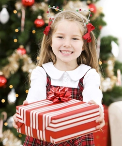 Close-up of a festive Christmas cat ear headband with colorful bells and red bows