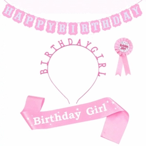 Close-up of pink Baby Shower set with MUMMY TO BE headband, satin sash and birthday badge