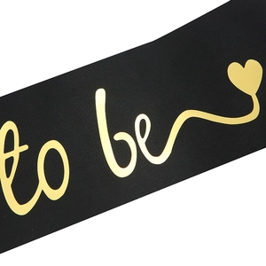 Elegant black satin Bride to Be sash with metallic gold cursive lettering and heart detail