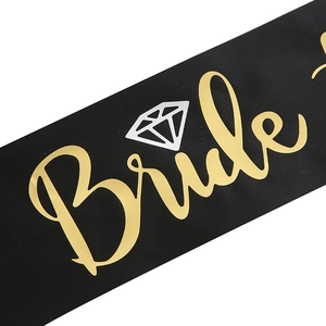 Detail of black satin Bride sash with gold foil font and white diamond graphic