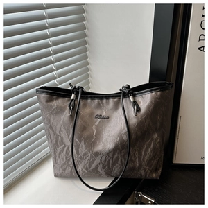 Detail view of large grey tote bag with marble texture, leather straps and Balina logo