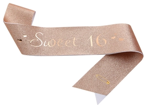 Detail of rose gold glitter sash with Sweet 16 golden text and safety pin accessory