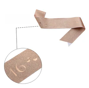 Close-up of rose gold Sweet 16 sash with gold foil lettering and safety pin detail