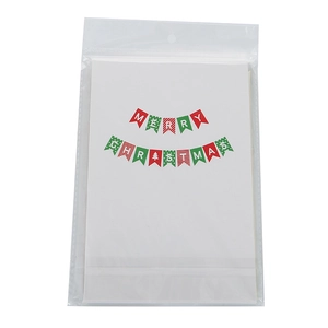 Macro shot of Merry Christmas paper banner set in clear plastic packaging