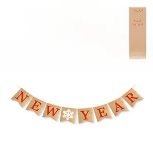 Macro detail of kraft paper Happy New Year bunting with red letters and white snowflakes