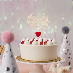 Golden Happy Birthday cake topper with crystal reindeer antlers and a red heart candle