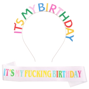 Close-up of rainbow birthday headband and white satin sash with colorful lettering
