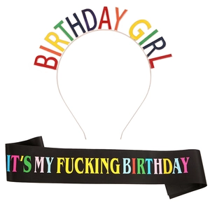 Colorful Birthday Girl headband and black satin sash party accessories set on white backdrop