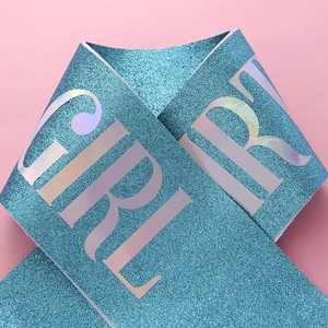Detail of blue glitter sash with silver laser Birthday Girl lettering for party decor