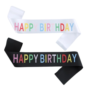 Close-up of black and white Happy Birthday party sashes with colorful lettering