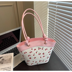 Close-up of pink and white cherry print shoulder bag in premium PU leather finish