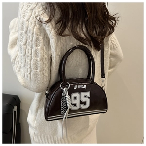 Detail view of the vintage brown crossbody bag featuring white 95 Los Angeles graphic print