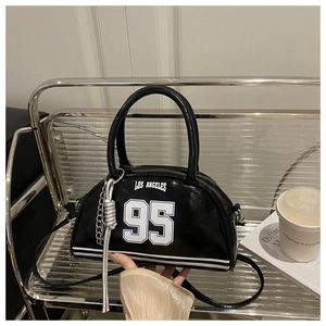 Detail of black PU leather bowling bag featuring Los Angeles 95 print and silver knot charm