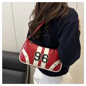Detail shot of red and white shoulder bag with 96 embroidery and metallic studs