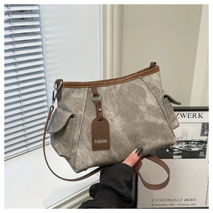 Detail of vintage canvas crossbody bag with multiple pockets and brown leather trim