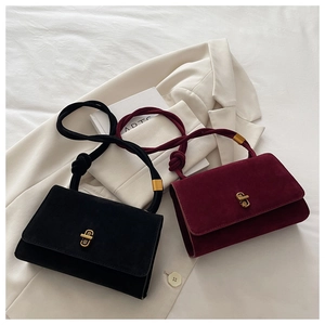 Detail of matte finish evening bags with knotted rope handles and gold metallic hardware