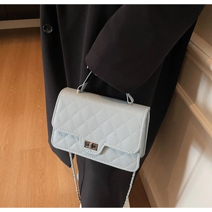 Quilted light blue leather crossbody bag with silver twist lock and chain strap detail