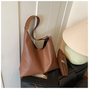Detail of a brown woven texture hobo bag set with matching small zipper pouch