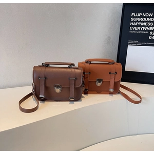 Macro detail of retro leather satchels with metal buckles and flap closures in autumn colors