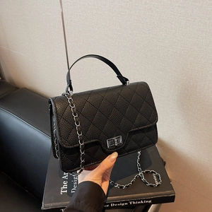 Quilted diamond lattice chain handbag with silver metal turn lock in black faux leather